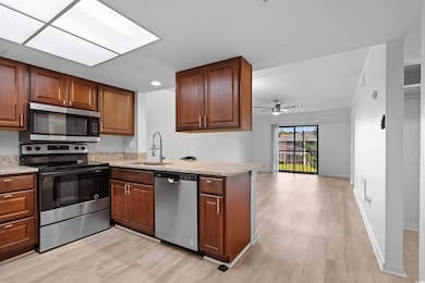 Kitchen with ceiling fan, sink, kitchen peninsula,