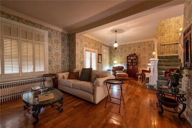 Large living room with original hardwood flooring.