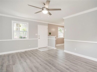 Living room lets in great natural light and is open to eat in kitchen. New windows throughout!