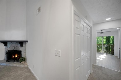 Hall with carpet flooring, baseboards, and a textu