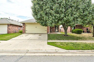View of front of home with a front yard and a gara