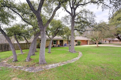 Ranch-style home with driveway, an attached garag