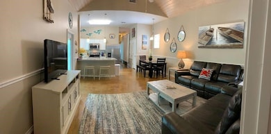 Living area featuring lofted ceiling, light wood-