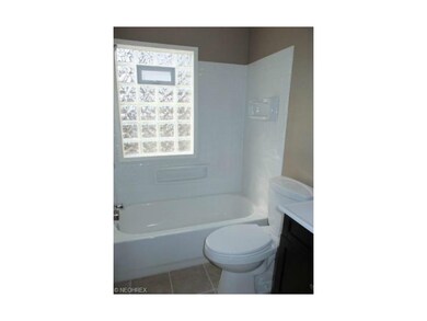 Remodeled full bath with tile floor, new vanity an