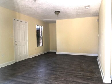 Unfurnished room with a textured ceiling and dark 