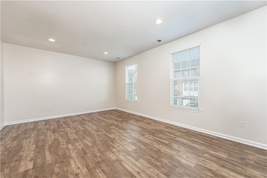 Spacious and open living room with great natural light and gorgeous luxury vinyl floors.
