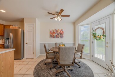 Bright breakfast room/dining space with bayed doors that walk out to the back patio.