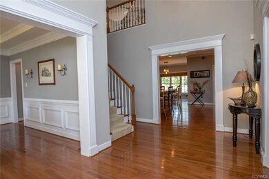 The soaring two story foyer welcomes you with quie