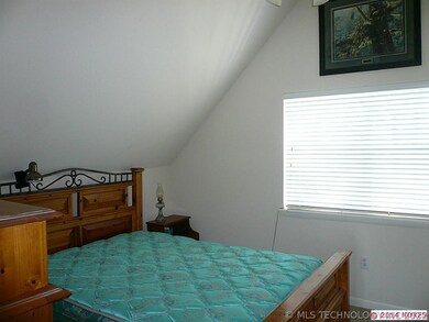 Upstairs master bedroom with vaulted ceiling.