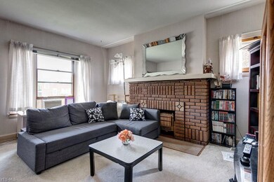 Downstairs unit living room with original brick fireplace!