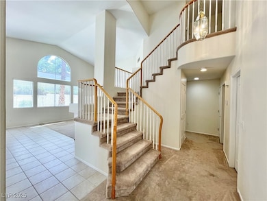 Stairway with lofted ceiling, carpet floors, and b