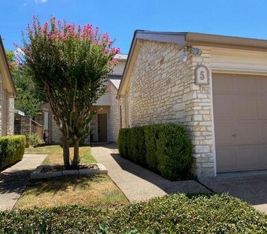 View of front of home with a garage and stone sid