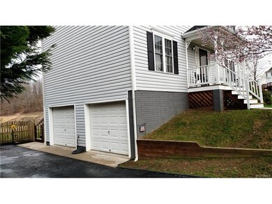 Side entry view into 2 Car Garage.  Door on left h