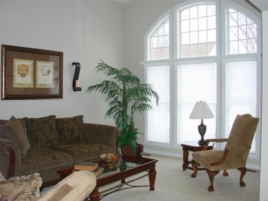 Formal Living Room features a cathedral ceiling & 