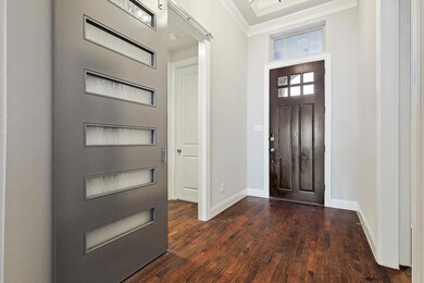 Foyer featuring tray ceiling with crown molding.