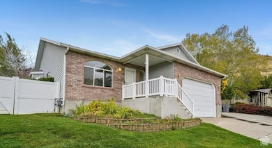 Ranch-style house with brick siding, concrete driveway, a garage, and a front lawn