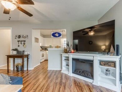 Living room featuring light hardwood / wood-style flooring and ceiling fan