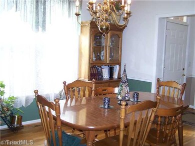 Dining Room. To the right of the foyer is the dining room with hardwood floors and crown molding.