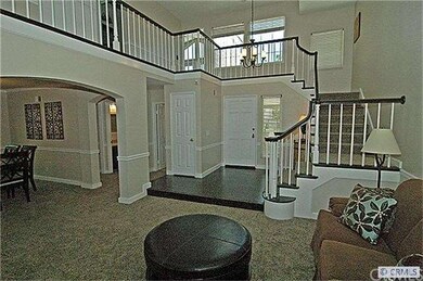 Formal living room with vaulted ceilings & lots of