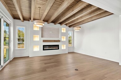 Unfurnished living room featuring hardwood / wood-