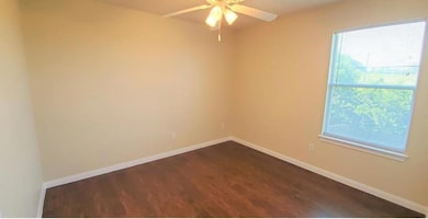 Empty room featuring dark wood-style flooring and