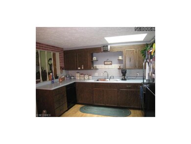 Large kitchen with laminate floors.