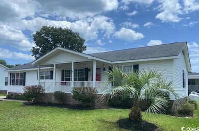 View of front of home featuring a front lawn, a porch, and crawl space