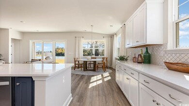 Kitchen featuring light countertops, white cabinet