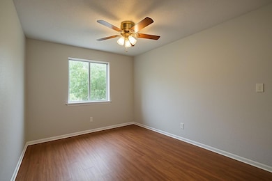 Unfurnished room featuring dark wood-style floors
