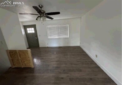 Foyer with ceiling fan, baseboards, and wood finished floors