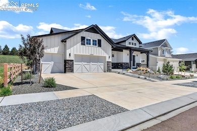 Modern farmhouse style home with board and batten siding, concrete driveway, an attached garage, stone siding, and roof with shingles