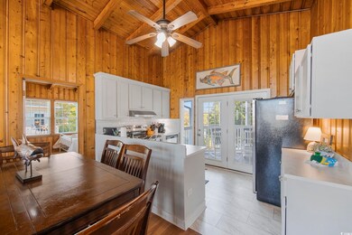 Kitchen featuring beam ceiling, appliances with st