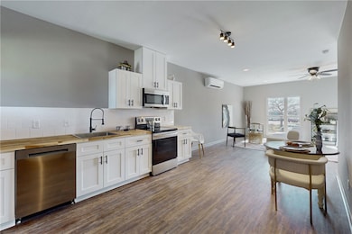 Kitchen featuring a wall unit AC, decorative backs
