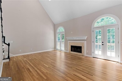 Fire-side family room with gleaming hardwood floors