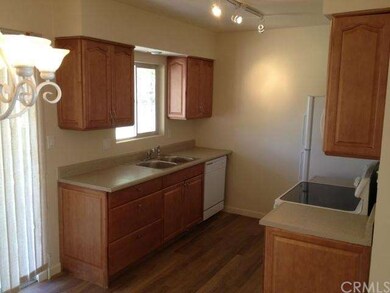 Kitchen with window that views fenced backyard