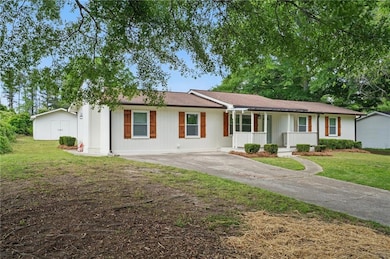 Single story home with covered porch, a front yard