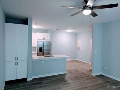 Kitchen with sink, white cabinets, stainless steel