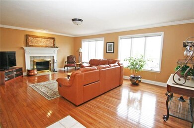 SPACIOUS family room with hardwood flooring, crown
