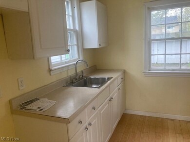 Kitchen featuring plenty of natural light and white cabinetry
