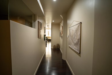 Corridor featuring dark wood-type flooring