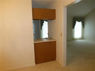 Wet bar from dining room to kitchen with view of l