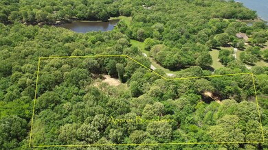 Aerial view featuring a water view and a wooded view