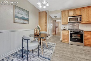 Kitchen featuring backsplash, wood tiled floor, lo
