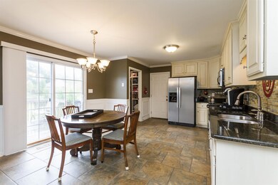 Spacious Kitchen with Granite Countertops, White Glazed Oak Cabinets, Tile Floors and Tile Back Splash