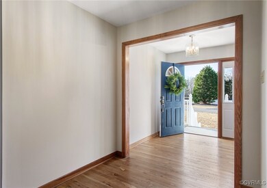 Foyer with hardwood floors, fresh paint and coat c