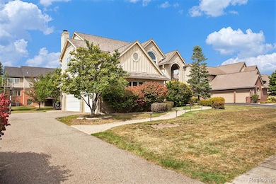 View of front of home featuring board and batten siding, a front lawn, a garage, and asphalt driveway