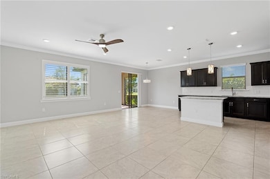 Kitchen with open floor plan, backsplash, crown mo