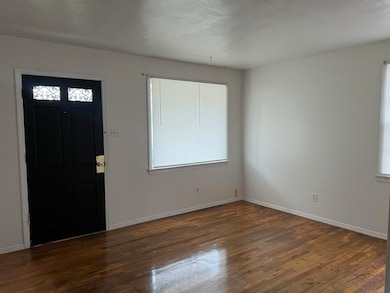 Foyer with dark hardwood / wood-style flooring