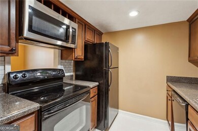 Kitchen with decorative backsplash, black appliances