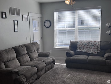 Living area with carpet and baseboards